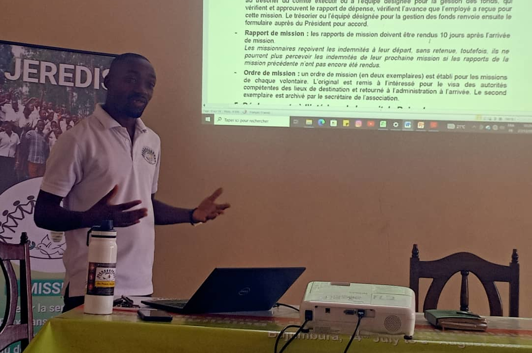 Facilitator and youth joining hands during a mediation workshop